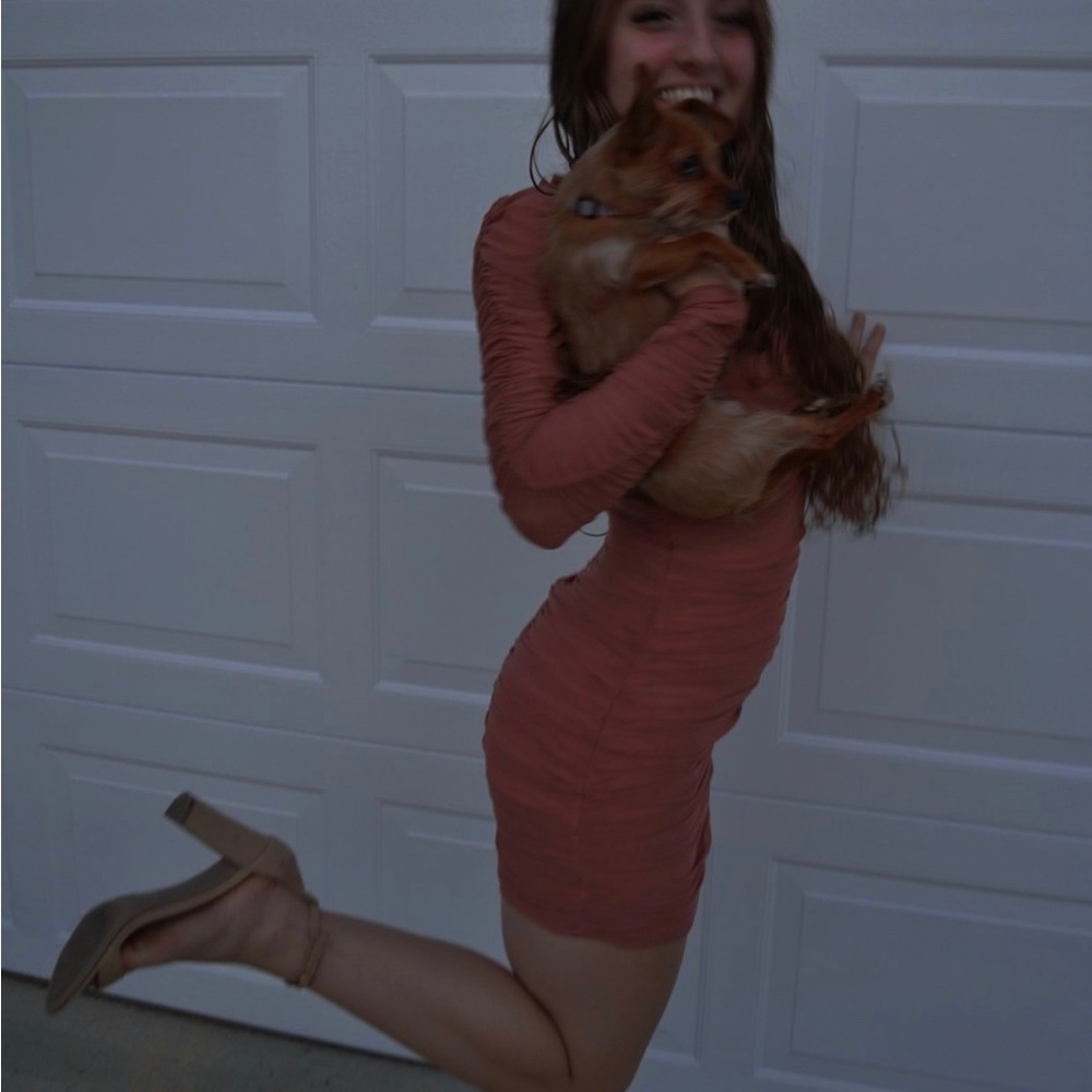 Rushed pink fashion nova bodycon dress with ruffled on the shoulder sleeves.